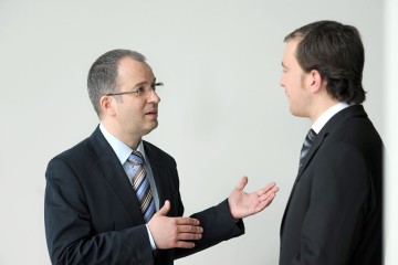 Das Bild zeigt zwei Männer beim Diskutieren.